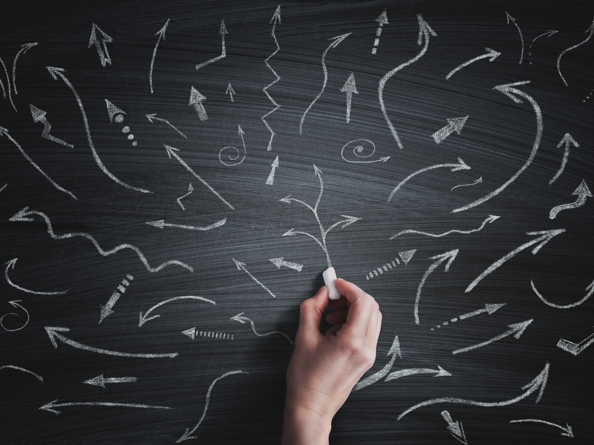 Many diverging arrows on a blackboard
